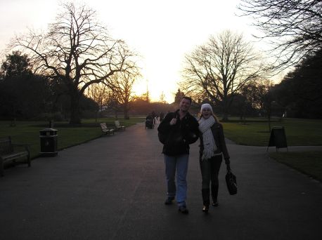 James and Joanna on a path in Kew, with the setting sun behind them