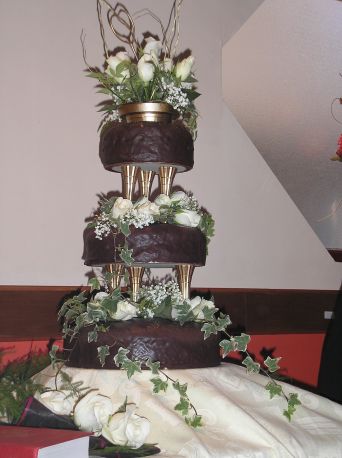 Three tier chocolate cake, decorated with ivy and white roses