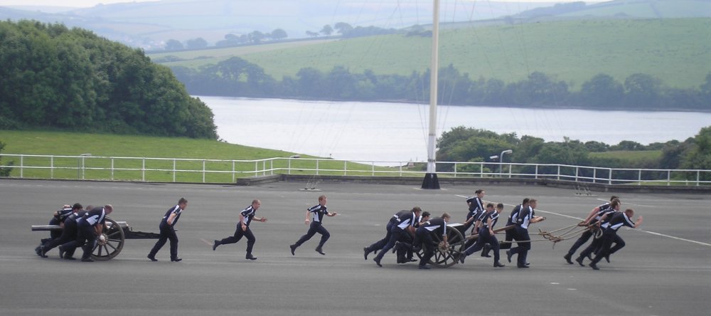 A navy team pull a cannon across the parade ground.
