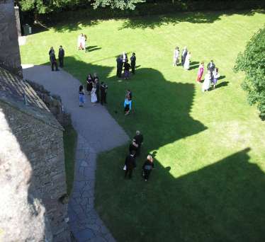 Looking down from the castle roof to the lawn where guests are gathering before the ceremony